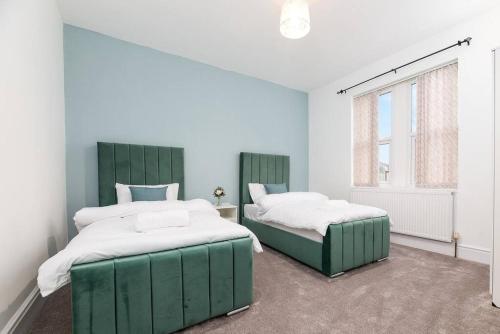 a bedroom with two beds and a window at Holiday Lodge, close to Nottingham City Centre in Nottingham