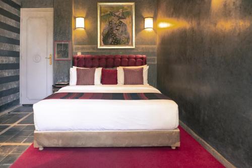 a bedroom with a large bed with a red headboard at La Maison de Tanger in Tangier