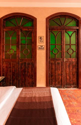 two wooden doors in a room with at La Maison de Tanger in Tangier