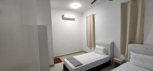 a small room with two beds and a window at AKMA HOMES DESARU in Bandar Penawar