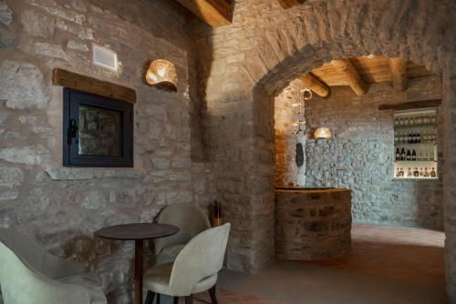 a wine tasting room with a table and chairs at Monastero Sant'Alberico Relais in Balze