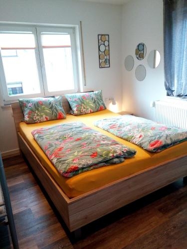a bed in a room with two pillows on it at Ferienwohnungen Busch`s Gästehaus in Rust