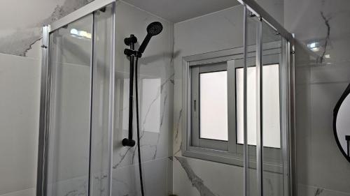 a shower in a bathroom with a window at STAY Sky Apartment in Limassol