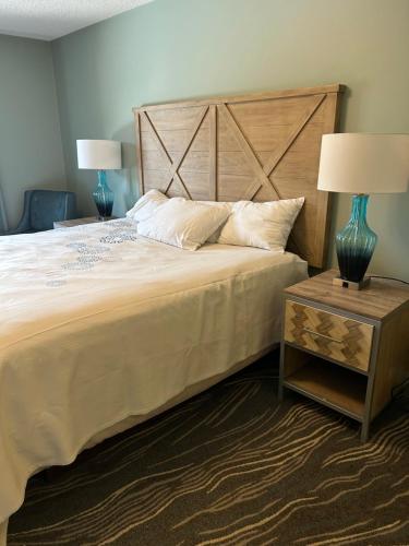 a bedroom with a large bed with a wooden headboard at Cozy 4BR Ski retreat and Water Park! in Massanutten