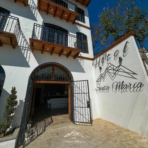 a building with a sign on the side of it at Hotel Santa María in Taxco de Alarcón