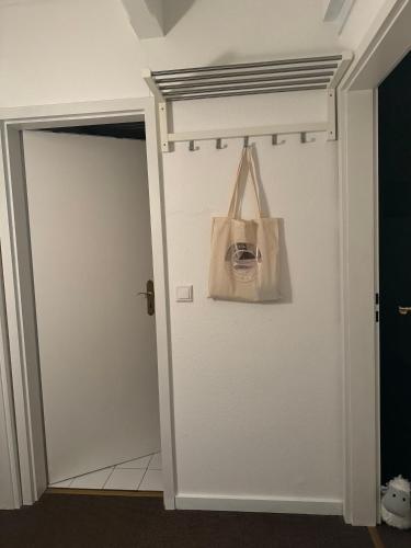 a bag hanging on a wall next to a door at Kleine Ella Pellworm in Pellworm