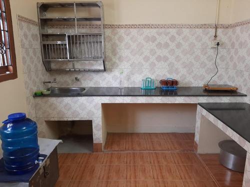 a kitchen with a sink and a counter top at Sea Edge Homestay in Port Blair