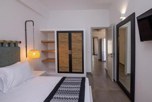 a bedroom with a bed and a hallway at Raffar luxury houses in Tinos Town