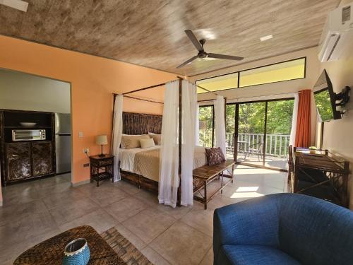 a bedroom with a bed and a living room at CASITAS SELVARA in Platanillo