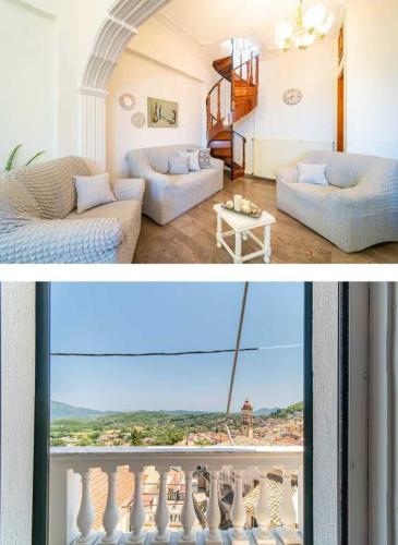 a living room with a couch and a balcony at Pavlos Sofia Suites in Corfu Town