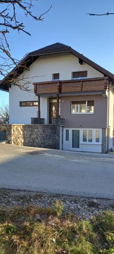 a large white house with a driveway at Apartment ROKO with sauna & view in Brod Moravice