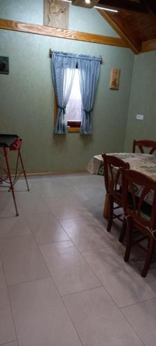 a room with a table and chairs and a window at Apartment ROKO with sauna & view in Brod Moravice