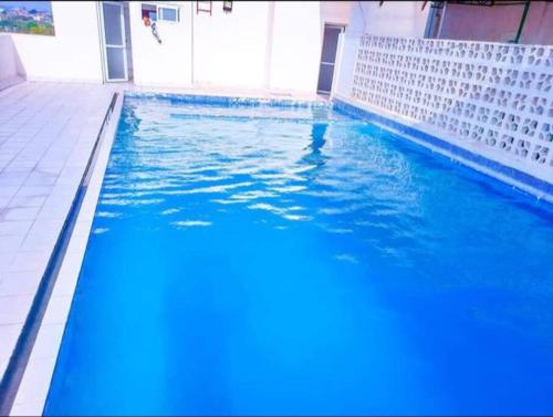 a large blue swimming pool in a building at 2 bedroom apt 323 Kisimani Heights, Mombasa, Kisimani in Mombasa