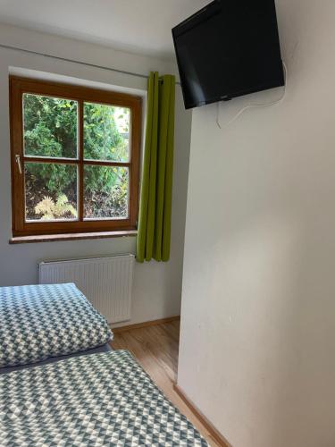 a bedroom with a bed and a window with green curtains at Apartment Sabrina in Sankt Johann im Pongau