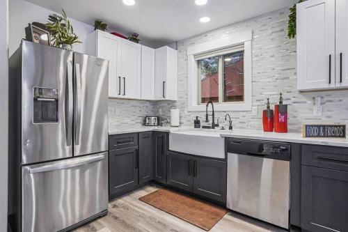 a kitchen with a stainless steel refrigerator and white cabinets at Ponderosa in McCall