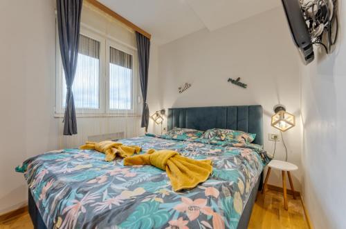 Un dormitorio con una cama con una manta encima. en Apartman Viktor & Matej Zlatibor, en Zlatibor