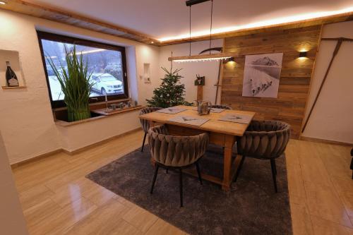 a dining room with a wooden table and chairs at Bergchalet Four Seasons in Reit im Winkl