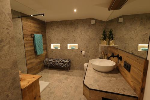 a bathroom with a sink and a toilet and a shower at Bergchalet Four Seasons in Reit im Winkl