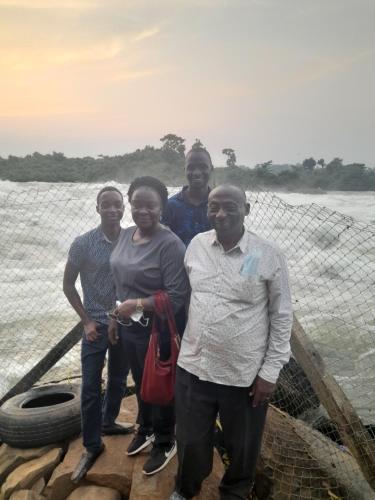 a group of people standing on a bridge at Jusvero Motel in Jinja