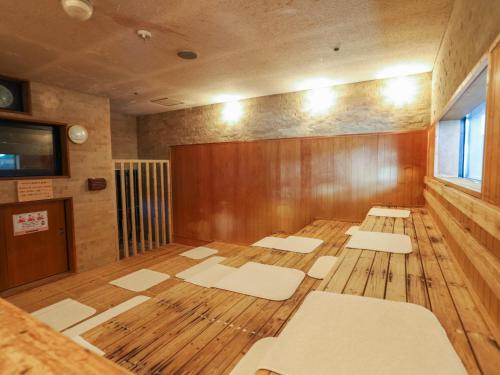 an empty room with mats on the floor of a room at Castle Inn Sendai in Sendai