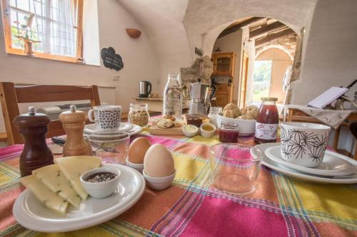 a table with plates of food and eggs on it at Agriturismo Malga Riondera in Ala