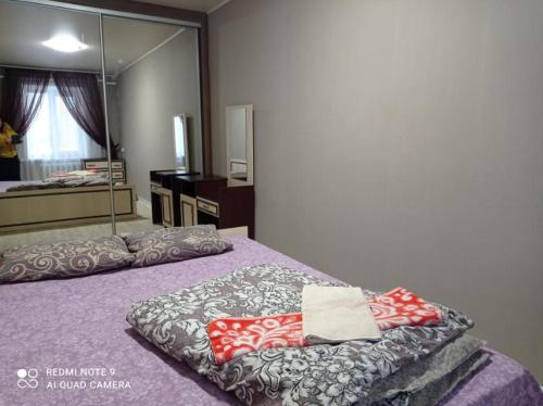 a bedroom with a bed with a mirror at Автовокзал Apartaments 2kv in Dnipro