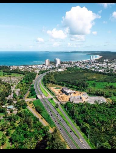 an aerial view of a city with a highway and the ocean at Cozy Cute Home 2nd floor pay at the property and we have many method of payments just ask us in Fajardo