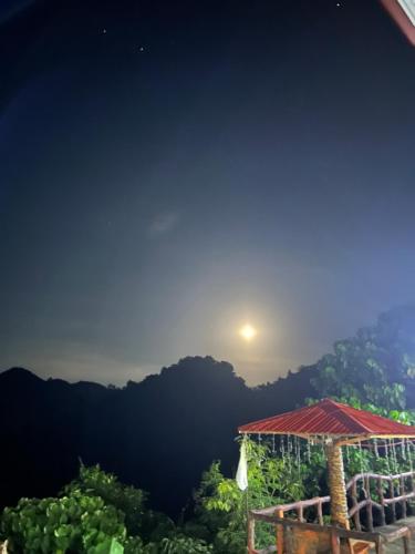 a view of the moon rising over the mountains at C View Resort in Sipalay