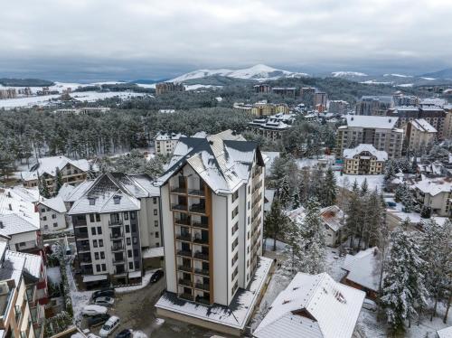 an aerial view of a city with snow covered buildings at Mans lux 8 Apartman in Zlatibor