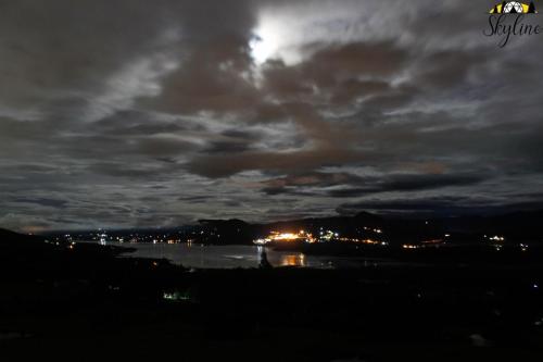 a moonlit view of a body of water at night at Skyline Glamping in Santuario