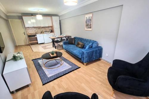 a living room with a blue couch and a table at Sisli Apartments in Istanbul