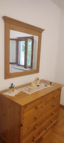 a wooden dresser with a mirror on top of it at Casa Baggino in Pistoia
