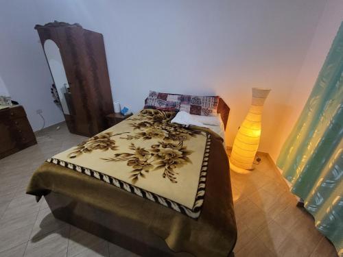 a bedroom with a bed and a vase on the floor at Garden house in Kashari