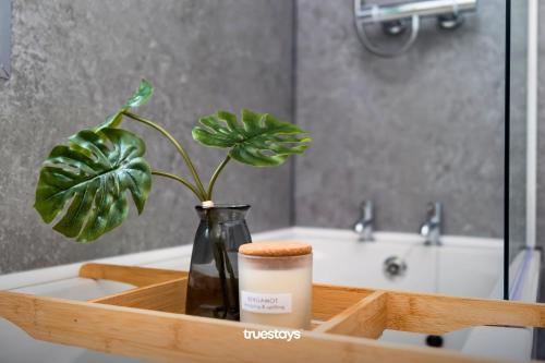 a wooden tray with a bottle and a plant on a sink at NEW Poplar House - Stunning 4 Bedroom House in Stoke-on-Trent in Newcastle under Lyme