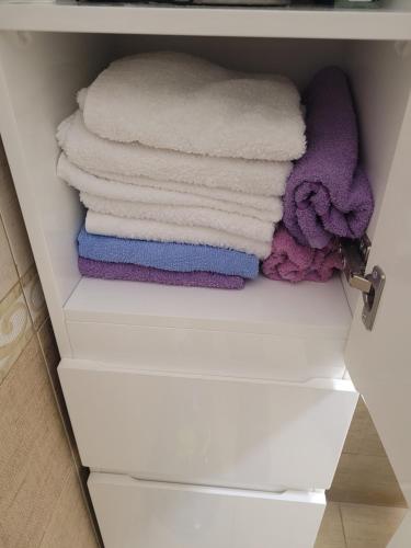 a stack of towels in a closet at Garden house in Kashari