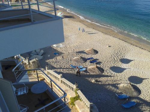 an overhead view of a beach with umbrellas at Magic Ionian Apartments & Rooms in Himare