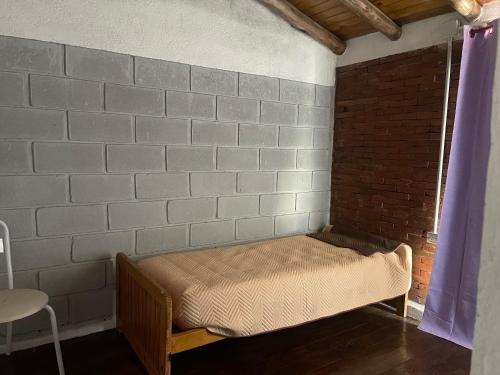 a room with a bed in a brick wall at Cab, SE ,1 in Villa Los Aromos