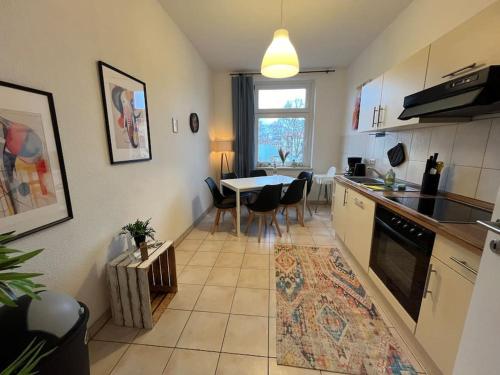 a kitchen with a table and a dining room at Blue Chili 00 - Moderne Familienwohnung, Top Lage in Magdeburg