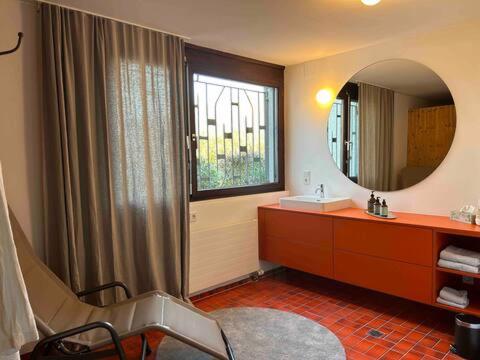 a bathroom with a sink and a mirror at HAUS A Ankommen*Abschalten*Auftanken in Bregenz