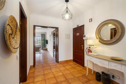 a hallway of a home with a mirror and a table at Vilamoura - Cozy and Quiet Holiday Apartment in Vilamoura
