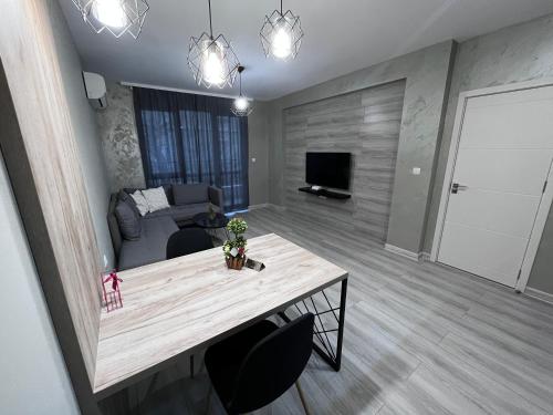 a living room with a table and a couch at Beautiful Apartment free Parking Garage in Plovdiv