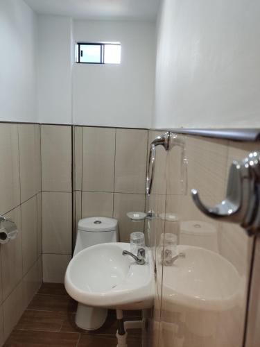 een badkamer met een wastafel en een toilet bij Condominio confortable in Talara