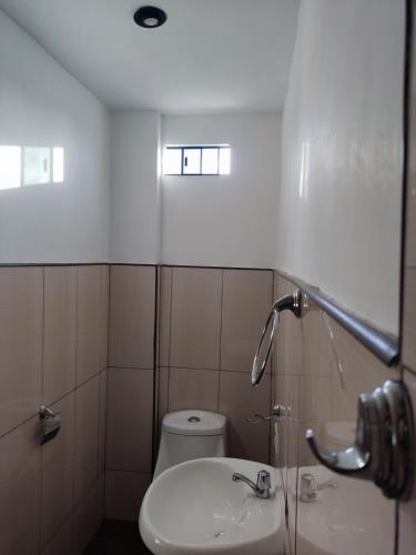 a bathroom with a sink and a toilet at Condominio confortable in Talara