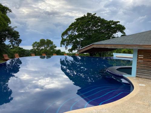 a pool with a reflection of the sky in the water at Apartment Diamond Hill Resort in Diamond Rock