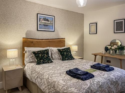 a bedroom with a bed with two pillows on it at Forest Acorn in Brockenhurst