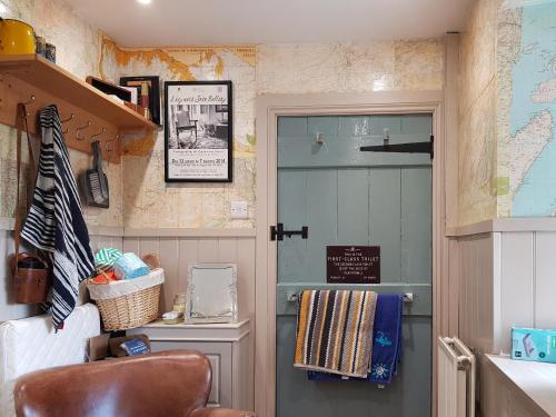 a room with a door and a map on the wall at Maines Farm Cottage in Chirnside