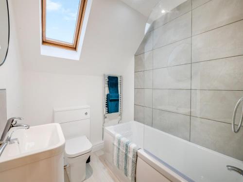 a bathroom with a tub and a toilet and a sink at Salix 4 - Uk46116 in Wigginton