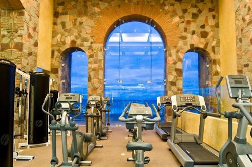a gym with several tread machines and a large window at Sonoran Sky Resort Vista a Playa Azul in Puerto Peñasco