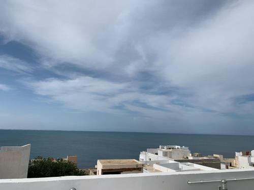 a view of the ocean from a building at Maison Fathallah in Mahdia