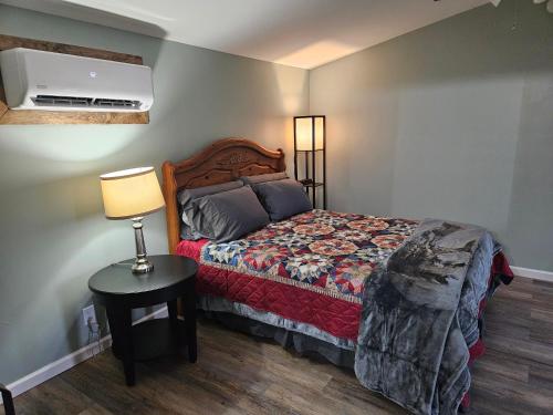 1 dormitorio con 1 cama y 1 lámpara en una mesa en Grey Pines at Hocking Vacations, en Logan